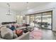 Cozy living room with hardwood floors, and a large sliding glass door to the lanai at 32484 Worden Pass, Wesley Chapel, FL 33543