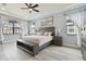 Tranquil main bedroom with a tray ceiling, soft natural light, and elegant decor at 32484 Worden Pass, Wesley Chapel, FL 33543