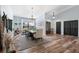 Bright dining room with wood flooring, chandelier, and a view of the double door entryway at 3275 Valemoor Dr, Palm Harbor, FL 34685