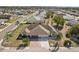 Well-maintained home with a brick driveway, lush landscaping, and a two-car garage at 335 Stroll Ln, Sun City Center, FL 33573