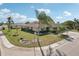 Corner lot home boasts verdant landscaping and an inviting front entrance at 335 Stroll Ln, Sun City Center, FL 33573