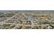Aerial view of a residential community showcasing an attractive neighborhood with lakes and golf course at 335 Stroll Ln, Sun City Center, FL 33573