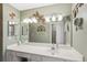 Bathroom featuring a large mirror, white countertops, and ample vanity storage at 335 Stroll Ln, Sun City Center, FL 33573