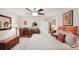 Bright bedroom features a ceiling fan, neutral colors, and a decorative vanity at 335 Stroll Ln, Sun City Center, FL 33573