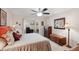 Spacious bedroom with a ceiling fan, a closet, and an attached office for convenience at 335 Stroll Ln, Sun City Center, FL 33573