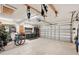 Spacious two car garage features utility cabinets and overhead storage at 335 Stroll Ln, Sun City Center, FL 33573