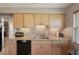 Kitchen featuring granite countertops, neutral cabinets, a stainless steel sink, and updated appliances at 335 Stroll Ln, Sun City Center, FL 33573