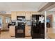 Well-lit kitchen features wooden cabinets, black appliances, and stylish countertops for cooking at 335 Stroll Ln, Sun City Center, FL 33573