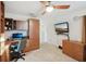 Home office with built-in desk, cabinets, and a mounted TV, perfect for work or leisure at 335 Stroll Ln, Sun City Center, FL 33573
