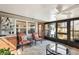 Sun room featuring tiled floors, ceiling fan and large windows at 335 Stroll Ln, Sun City Center, FL 33573