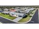 Aerial view of the streetscape featuring green lawns and various home roof styles at 37508 Gill Ave, Zephyrhills, FL 33541