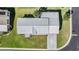 Aerial view of home with a well-maintained lawn, roof, and spacious driveway at 37508 Gill Ave, Zephyrhills, FL 33541