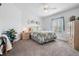 Comfortable bedroom with a ceiling fan, soft carpet, and a window providing natural light at 37508 Gill Ave, Zephyrhills, FL 33541