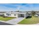 Charming single-story home with well-maintained landscaping, a paved driveway and carport, set in a friendly community at 37508 Gill Ave, Zephyrhills, FL 33541