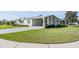 Pleasant home featuring a well maintained lawn, an attached carport, and manicured shrubbery at 37508 Gill Ave, Zephyrhills, FL 33541