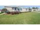Charming home featuring a well maintained lawn, cozy entryway, and manicured shrubbery at 37508 Gill Ave, Zephyrhills, FL 33541