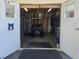 View of a garage with a golf cart, storage shelves, license plates, and workbench at 37508 Gill Ave, Zephyrhills, FL 33541