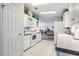 Well-lit kitchen featuring white cabinets, modern appliances, and tiled flooring at 37508 Gill Ave, Zephyrhills, FL 33541