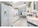 Bright kitchen with white appliances, tile flooring, and ample cabinet space at 37508 Gill Ave, Zephyrhills, FL 33541
