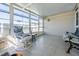 Relaxing sunroom with large windows and comfortable seating, perfect for enjoying natural light and views at 37508 Gill Ave, Zephyrhills, FL 33541