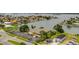 Aerial view showcasing a waterfront property with lush greenery and a glimpse of the tranquil bay at 400 Island Way # 612, Clearwater Beach, FL 33767