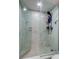 Modern bathroom shower with white marble tile, rainfall showerhead, and glass doors at 400 Island Way # 612, Clearwater Beach, FL 33767