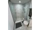 Modern bathroom with white marble tile, rainfall showerhead, and glass doors at 400 Island Way # 612, Clearwater Beach, FL 33767