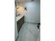 Bathroom with marble floors and countertops, black hardware, and modern vanity mirror at 400 Island Way # 612, Clearwater Beach, FL 33767