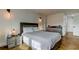 Bright, spacious bedroom with herringbone floors, neutral decor, and large window at 400 Island Way # 612, Clearwater Beach, FL 33767