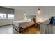 Modern bedroom with herring bone floors, neutral tones, and ample natural light at 400 Island Way # 612, Clearwater Beach, FL 33767