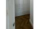 View of closet with custom white shelving and dark-stained herringbone wood flooring at 400 Island Way # 612, Clearwater Beach, FL 33767