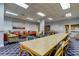 Common area with a long table, comfortable armchairs and library at 400 Island Way # 612, Clearwater Beach, FL 33767