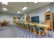 Well-lit conference room with a large table, chairs, and a mounted TV screen at 400 Island Way # 612, Clearwater Beach, FL 33767