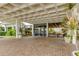 Beautiful building entrance with brick pavers, an intricate awning, and tropical landscaping at 400 Island Way # 612, Clearwater Beach, FL 33767