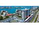 Condominium building with balconies, parking, a swimming pool, and beautiful views of the surrounding waterfront at 400 Island Way # 612, Clearwater Beach, FL 33767