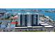 Aerial view of condo building, parking, and waterfront, offering an urban living experience at 400 Island Way # 612, Clearwater Beach, FL 33767