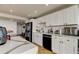 Updated kitchen features white cabinets, stainless appliances and black hardware and fixtures at 400 Island Way # 612, Clearwater Beach, FL 33767