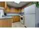 Functional kitchen with wood cabinets, appliances, and ample counter space at 400 Island Way # 612, Clearwater Beach, FL 33767