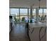 Bright kitchen with white cabinets, quartz countertops, pendant lighting and floor-to-ceiling windows with balcony at 400 Island Way # 612, Clearwater Beach, FL 33767