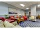 Relaxing lounge with comfortable seating, nautical themed artwork and bookshelves at 400 Island Way # 612, Clearwater Beach, FL 33767