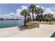 Charming patio overlooking the waterfront with palm trees and seating to enjoy the view at 400 Island Way # 612, Clearwater Beach, FL 33767