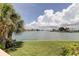 Breathtaking waterfront view with lush green lawn, and the blue waters meet under a beautiful sky at 400 Island Way # 612, Clearwater Beach, FL 33767