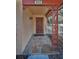 Elegant front porch featuring decorative metalwork, stone flooring, and a classic wooden door at 411 Kentucky Ave, Crystal Beach, FL 34681