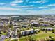 Community aerial view highlighting the building, clubhouse, and lush landscaping at 4240 Ironwood Cir # 404, Bradenton, FL 34209