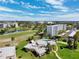 Expansive aerial view showcasing the building's setting with a lush golf course and blue skies at 4240 Ironwood Cir # 404, Bradenton, FL 34209