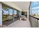Screened balcony showcases tile floors, patio furniture, and glass sliding doors at 4240 Ironwood Cir # 404, Bradenton, FL 34209