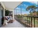 Relaxing screened balcony features wicker furniture, tile flooring, and scenic views at 4240 Ironwood Cir # 404, Bradenton, FL 34209