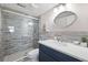 Modern bathroom with tiled walk-in shower, updated vanity and stylish mirror at 4240 Ironwood Cir # 404, Bradenton, FL 34209