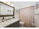 Well-maintained bathroom features a shower curtain, framed mirror, and vanity at 4240 Ironwood Cir # 404, Bradenton, FL 34209