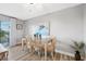 Bright dining area with table setting, natural light, and modern decor that opens to a balcony at 4240 Ironwood Cir # 404, Bradenton, FL 34209